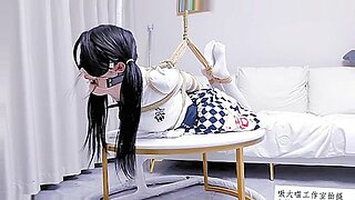 Chinese beauty bound upside down, teasing with foot play and silence.