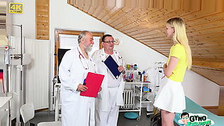 Two experienced doctors, Tim Wetman and Pavel Terrier, examine a stunning blonde teen.