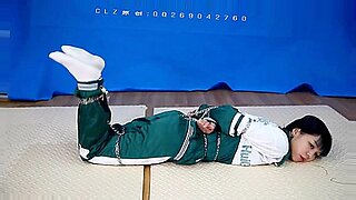 Chinese beauty bound and gagged in erotic display.