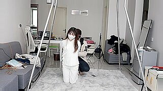 Cute Asian girl tied up, gagged, and teased for pleasure.